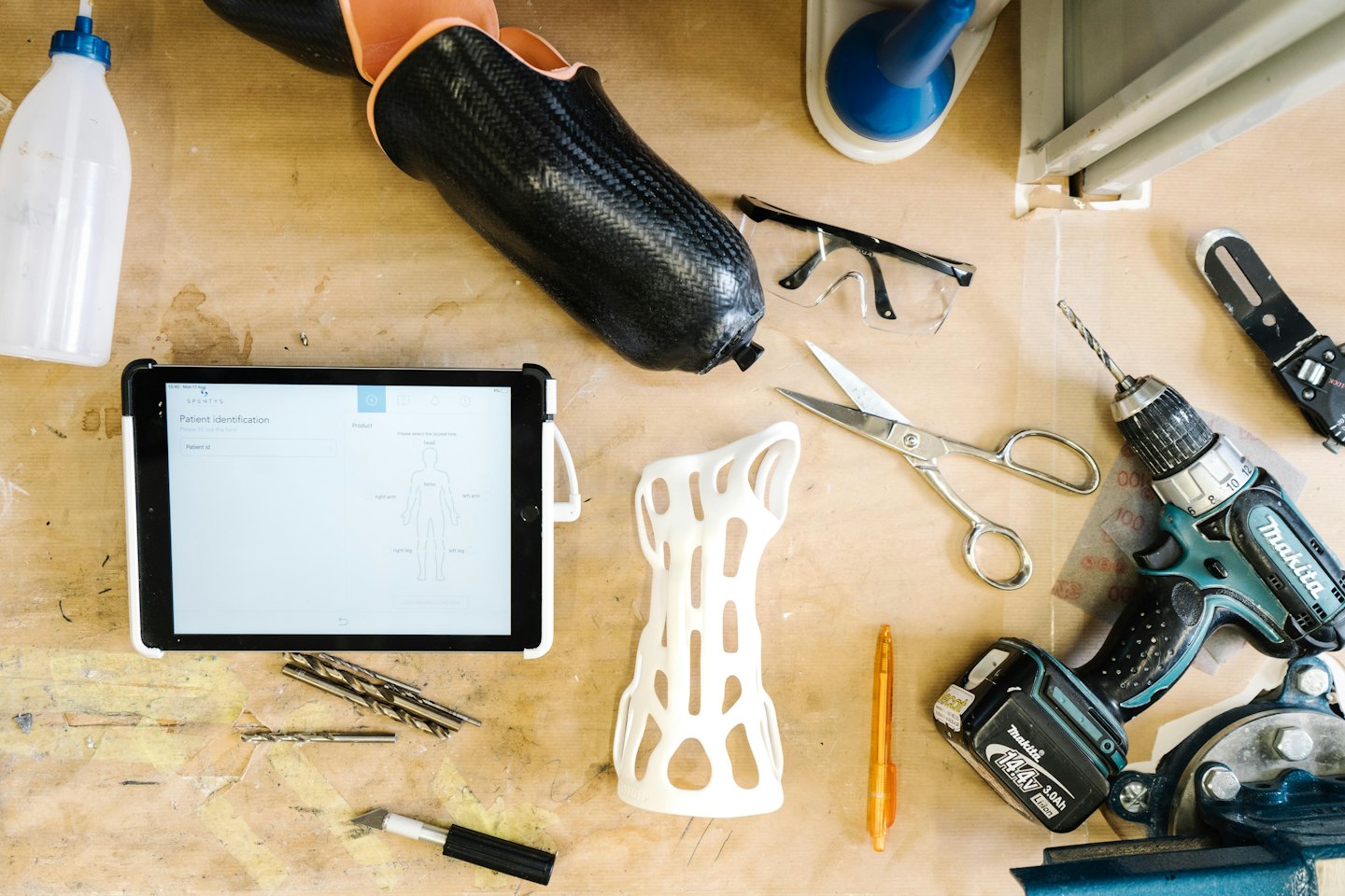 Prosthetic leg and medical devices on a workbench.